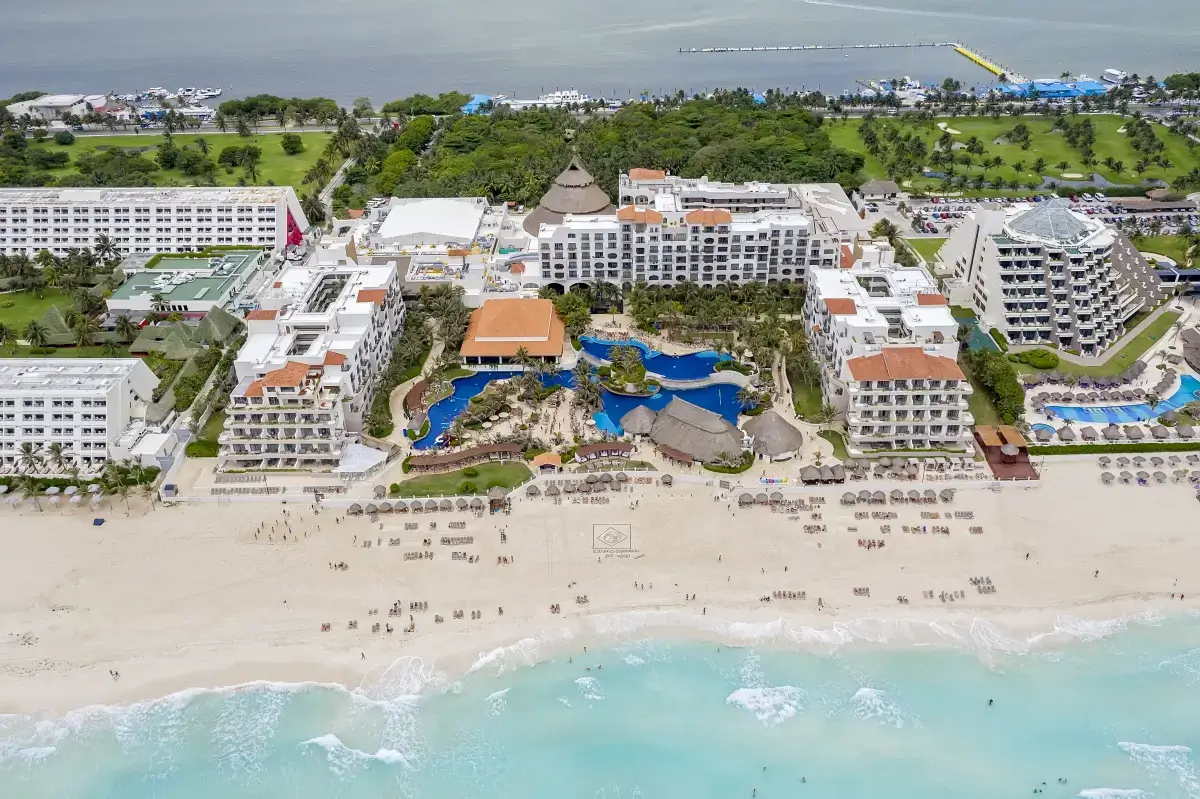 Aerial drone photo of a beachfront resort with pools and white sand beach, Cancun, Mexico