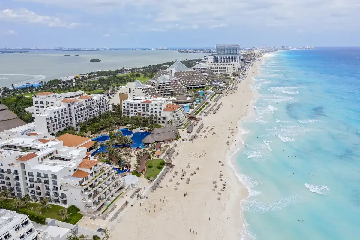 Aerial drone panorama of the Cancun hotel zone coastline with resorts and turquoise surf