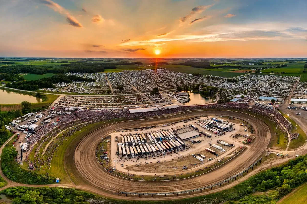 Aerial sunset panorama of Eldora Speedway dirt track, grandstands, and infield pits, Rossburg Ohio